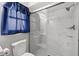 Bathroom featuring a toilet and a shower with white subway tile and a glass door at 1023 Springtime Dr, Holiday, FL 34691