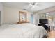 Bright bedroom with a ceiling fan, a TV, and a door to the backyard at 1023 Springtime Dr, Holiday, FL 34691