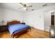 Bedroom with hardwood floors, ceiling fan, and walk in closet at 1023 Springtime Dr, Holiday, FL 34691