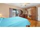 Spacious bedroom with a light blue bedspread and large mirror sliding glass doors at 1023 Springtime Dr, Holiday, FL 34691