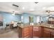 Spacious dining area with an adjacent kitchen and living room with a ceiling fan that offers comfortable seating at 1023 Springtime Dr, Holiday, FL 34691