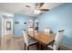 Bright dining room with a modern table set and tile floors, perfect for Gathering gatherings and entertaining guests at 1023 Springtime Dr, Holiday, FL 34691