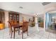 Inviting dining area connected to the living room, featuring tile flooring and abundant natural light, great for entertaining at 1023 Springtime Dr, Holiday, FL 34691