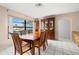 Cozy dining room with a window, nice cabinet, and tile floors, perfect for enjoying meals with Gathering and friends at 1023 Springtime Dr, Holiday, FL 34691