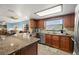 Well-equipped kitchen featuring granite counters, modern appliances, and seamless access to the living area at 1023 Springtime Dr, Holiday, FL 34691