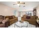 Inviting living room featuring cozy sofas, ceiling fan, and bright natural light at 1023 Springtime Dr, Holiday, FL 34691