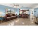 Inviting living room featuring a cozy couch, tile flooring, and an open layout to the kitchen, ideal for entertaining at 1023 Springtime Dr, Holiday, FL 34691