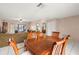Open living room view with dining, furnishings, and a view to the patio and outdoor spaces at 1023 Springtime Dr, Holiday, FL 34691