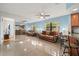 Bright living room with large mirror, comfortable couch, and views to the kitchen with bar seating at 1023 Springtime Dr, Holiday, FL 34691