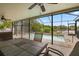 Outdoor dining area overlooks the pool and lake, complemented by ceiling fans for comfortable gatherings at 1023 Springtime Dr, Holiday, FL 34691