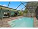 Screened-in pool with patio and lake view at 1023 Springtime Dr, Holiday, FL 34691