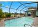Screened-in pool with patio and lake view at 1023 Springtime Dr, Holiday, FL 34691