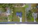 Aerial view of house with gray roof and nice lawn on a landscaped lot at 10262 Maybird Ave, Weeki Wachee, FL 34613