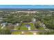 Aerial view of a home nestled amidst trees, showcasing its location within a wooded community at 10262 Maybird Ave, Weeki Wachee, FL 34613
