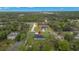 An aerial view of a cozy home in a lush, green neighborhood setting at 10262 Maybird Ave, Weeki Wachee, FL 34613