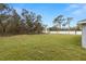 Expansive backyard with lush green grass, privacy fence, and a well-manicured lawn at 10262 Maybird Ave, Weeki Wachee, FL 34613