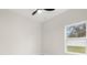 Bright bedroom featuring a modern ceiling fan and a window overlooking the yard at 10262 Maybird Ave, Weeki Wachee, FL 34613