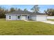 Charming single-story home with a paved driveway, attached garage, and well-manicured lawn at 10262 Maybird Ave, Weeki Wachee, FL 34613