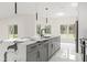 Open kitchen featuring marble countertop island, stainless steel dishwasher, and pendant lighting at 10262 Maybird Ave, Weeki Wachee, FL 34613