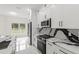 Open concept kitchen featuring stainless steel appliances and white cabinets at 10262 Maybird Ave, Weeki Wachee, FL 34613