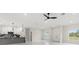 Bright open-concept living area with a stylish kitchen with an island and white kitchen cabinets at 10262 Maybird Ave, Weeki Wachee, FL 34613