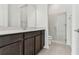 Bathroom featuring dark wood vanity with quartz countertop, and glass shower at 11423 Shoreline Trl, Parrish, FL 34219