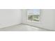 Bright bedroom features window and tile floor at 11423 Shoreline Trl, Parrish, FL 34219