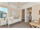 Bedroom featuring a comfortable daybed, stylish lighting, and a view into the ensuite bathroom at 11423 Shoreline Trl, Parrish, FL 34219