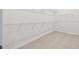 Walk-in closet includes wire shelving and tile floor at 11423 Shoreline Trl, Parrish, FL 34219