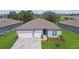 Charming single-Gathering home featuring a two-car garage, inviting entrance, and well-maintained landscaping at 11423 Shoreline Trl, Parrish, FL 34219