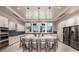 Bright kitchen featuring stainless steel appliances, large island with bar seating, and contemporary pendant lighting at 11423 Shoreline Trl, Parrish, FL 34219