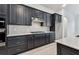 Stylish kitchen boasts dark cabinets, a gas range, and tile backsplash for a modern look at 11423 Shoreline Trl, Parrish, FL 34219