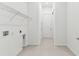 Laundry room features shelving, tile floor, and utility connections at 11423 Shoreline Trl, Parrish, FL 34219