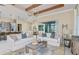 Open living space featuring stylish sofas, a modern coffee table, and a view of the adjacent kitchen and dining area at 11423 Shoreline Trl, Parrish, FL 34219