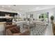 Bright, open-concept living room features a modern kitchen, comfortable seating, and plenty of natural light at 11423 Shoreline Trl, Parrish, FL 34219