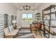 Bright living room with white walls, modern chandelier, wine racks, and large windows overlooking lush greenery at 11423 Shoreline Trl, Parrish, FL 34219