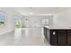 Expansive living area showcasing tile flooring, natural light, and sliding glass doors to the backyard at 11423 Shoreline Trl, Parrish, FL 34219