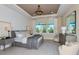 Relaxing main bedroom with a plush bed, soft lighting, neutral tones, and a view of the outdoors at 11423 Shoreline Trl, Parrish, FL 34219