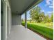 Covered patio with view of green lawn at 11423 Shoreline Trl, Parrish, FL 34219