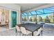 Outdoor patio with a large dining table, chairs, and view of the screened-in pool and spa area at 11423 Shoreline Trl, Parrish, FL 34219