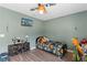 Comfortable bedroom featuring a ceiling fan, modern flooring and colorful accents at 11449 Crestlake Village Dr, Riverview, FL 33569