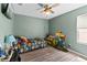 Charming bedroom boasting updated flooring, a ceiling fan, and playful décor at 11449 Crestlake Village Dr, Riverview, FL 33569