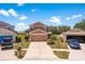 Two-story house with neutral paint, two-car garage and front yard with flower beds at 11449 Crestlake Village Dr, Riverview, FL 33569