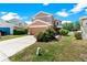 Two-story house with neutral paint, two-car garage and front yard with flower beds at 11449 Crestlake Village Dr, Riverview, FL 33569