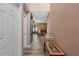 Hallway leading to a spacious living area with neutral paint, laminate flooring, and plenty of natural light at 11449 Crestlake Village Dr, Riverview, FL 33569