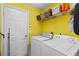 Laundry room with white washer and dryer and wire rack for storage at 11449 Crestlake Village Dr, Riverview, FL 33569