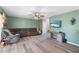 Comfortable living room with laminate floors, ceiling fan, a TV, and ample seating at 11449 Crestlake Village Dr, Riverview, FL 33569