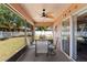 Relaxing screened-in porch area featuring a ceiling fan and backyard views at 11449 Crestlake Village Dr, Riverview, FL 33569