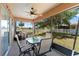 Relaxing screened-in porch area featuring a ceiling fan and backyard views at 11449 Crestlake Village Dr, Riverview, FL 33569