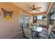 Charming screened-in porch with ceiling fan and butterfly themed decorations at 11449 Crestlake Village Dr, Riverview, FL 33569